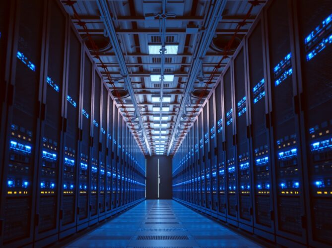 Interior of a modern data center with illuminated server racks and networking equipment
