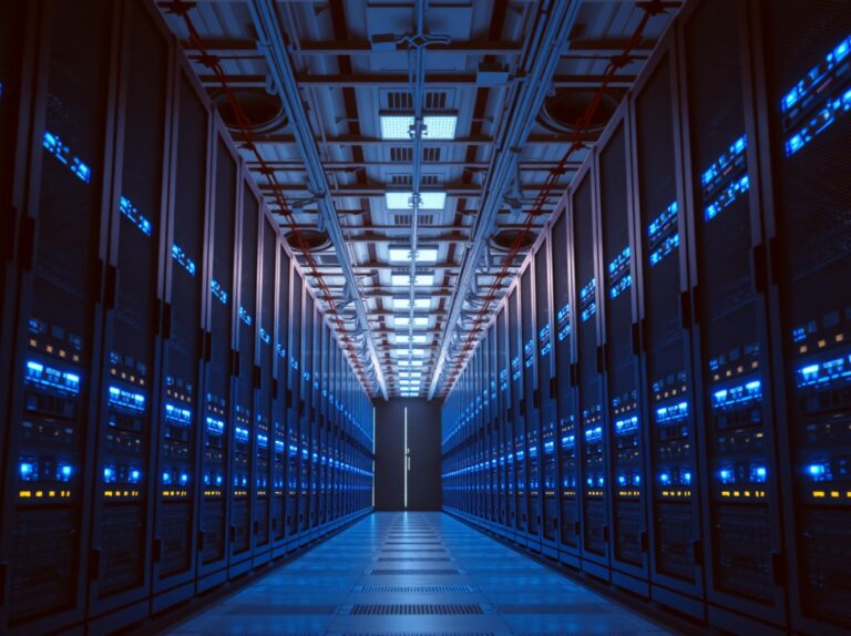 Interior of a modern data center with illuminated server racks and networking equipment